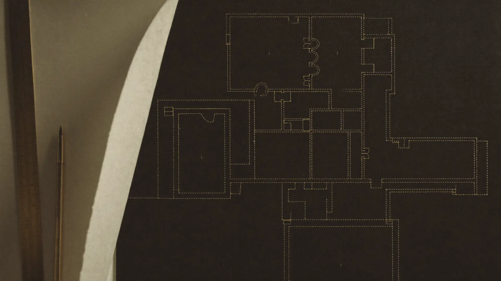 Gold-ink system blueprint drafted on graphite paper under low light