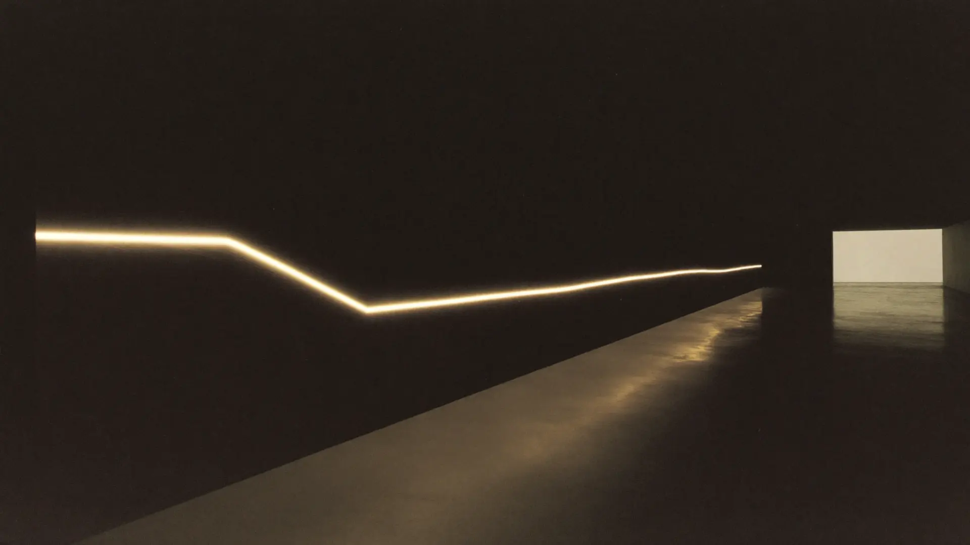 A single gold light path travelling through a dark architectural corridor